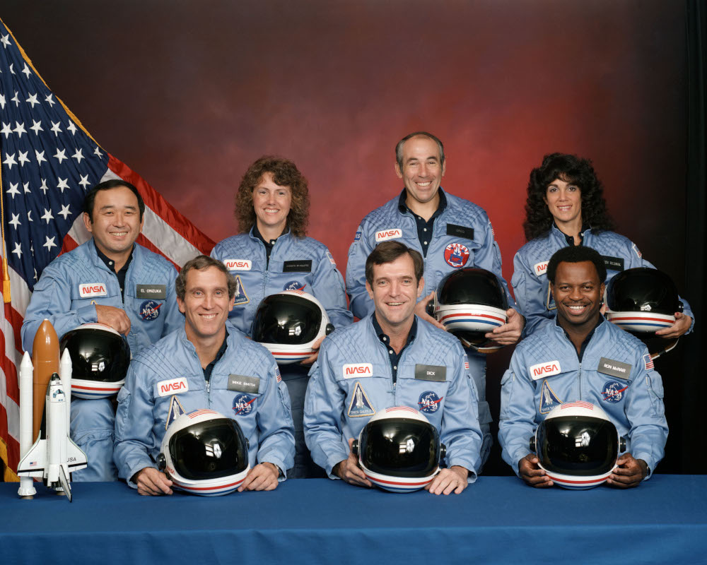 In the back row from left to right: Ellison S. Onizuka, Sharon Christa McAuliffe, Greg Jarvis, and Judy Resnik. In the front row from left to right: Michael J. Smith, Dick Scobee, and Ron McNair.